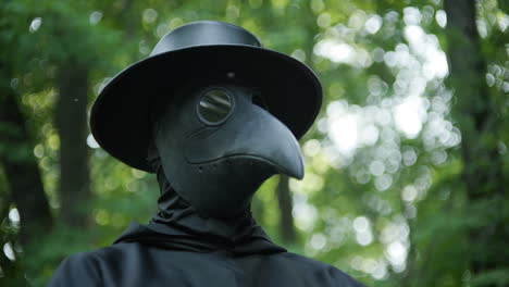 Plague-doctor-standing-in-woods-in-slow-motion