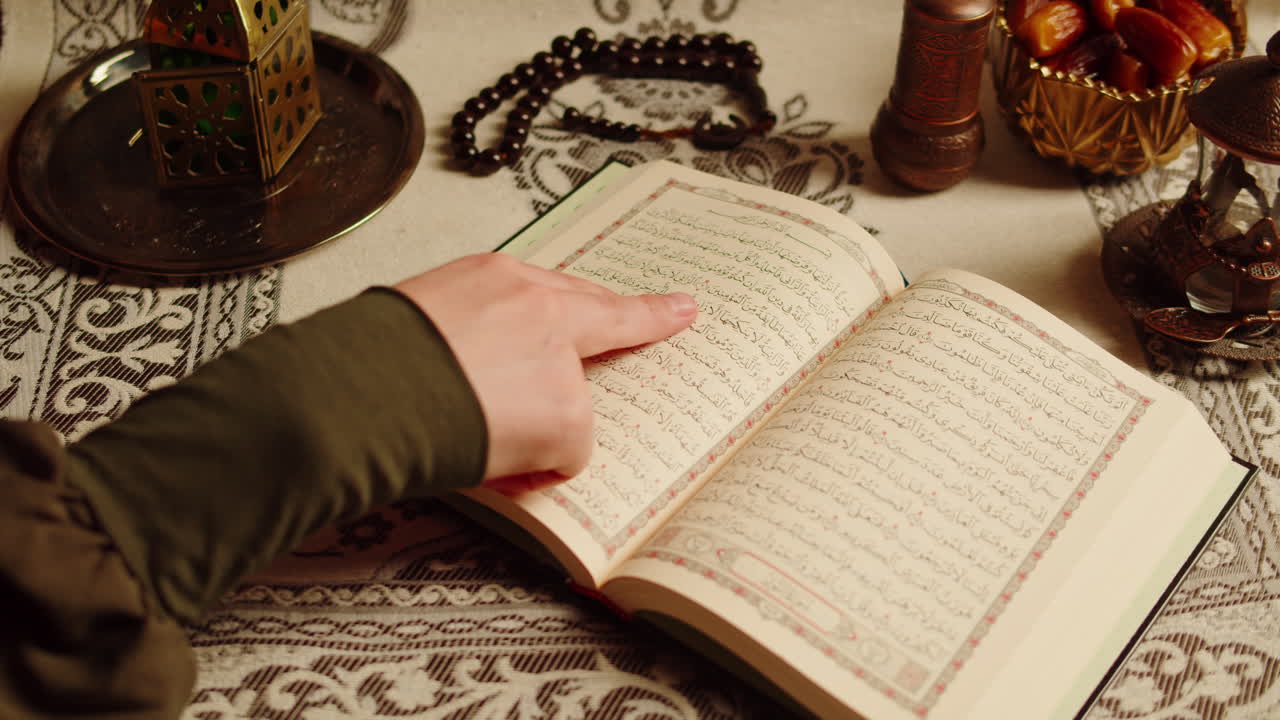 Quran book close-up, praying, islamic religion. Religious holiday Ramadan, holy month. Worship, making traditional prayer to God