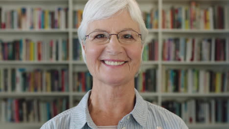 close up portrait of elegant middle aged woman teacher smiling happy looking at camera elderly lady wearing glasses in library