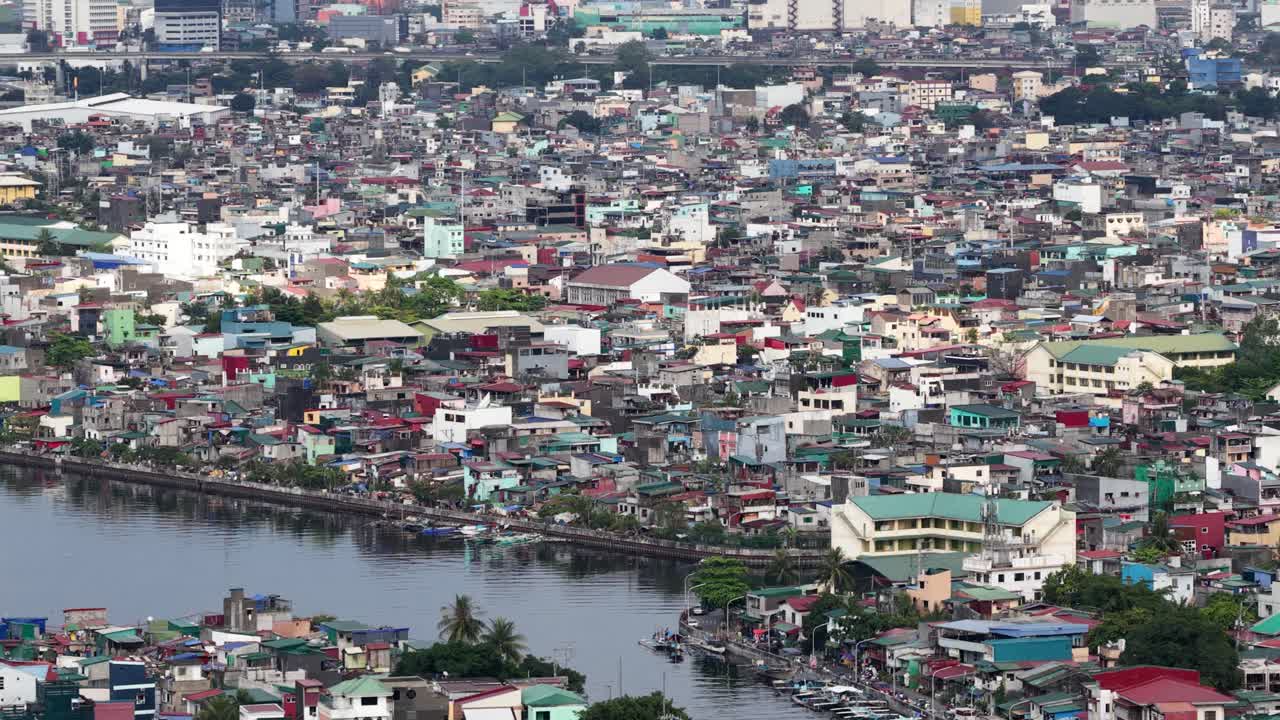 Aerial view of a densely populated urban residential area with impoverished housing, showing the stark contrast of poverty and overpopulation in a developing country's metropolitan city