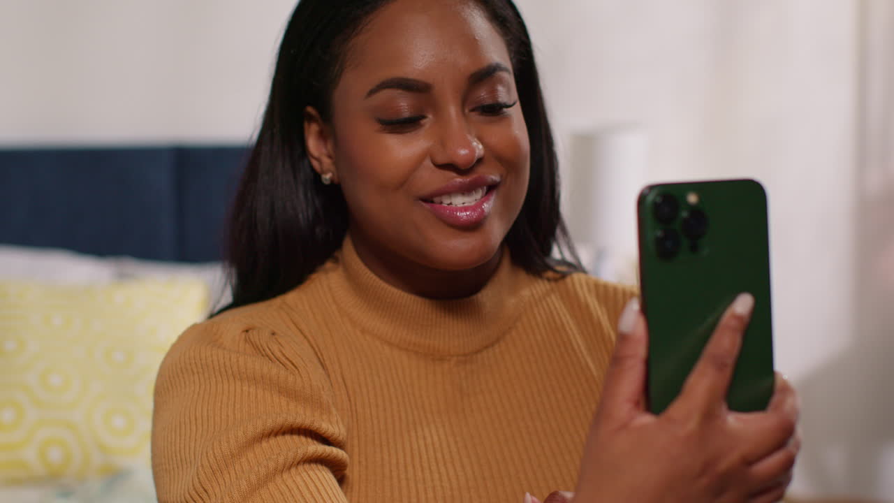 Woman having a video call in her bedroom