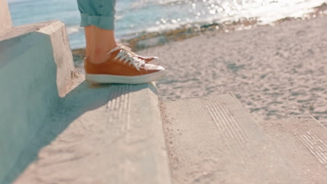 close up feet woman walking down steps on beach enjoying warm sunny day carefree girl exploring summer vacation lifestyle