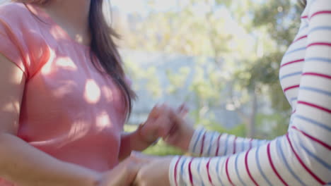 holding hands, two asian mother and daughter bonding and enjoying time together outdoors
