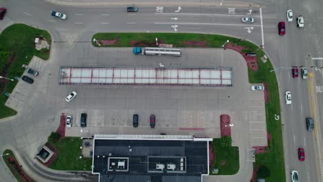 top-down-aerial-of-Tanker-semi-truck-that-unloads-fuel-at-gas-station