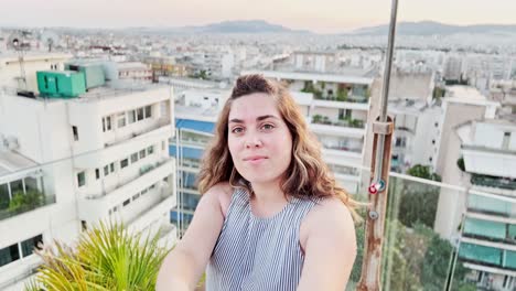 woman's natural selfie on athens rooftop with plant