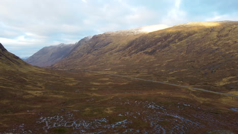 Slow-moving-aerial-shot-of-the-hills-and-mountains-at-Glencoe,-Scotland-in-Great-Britain