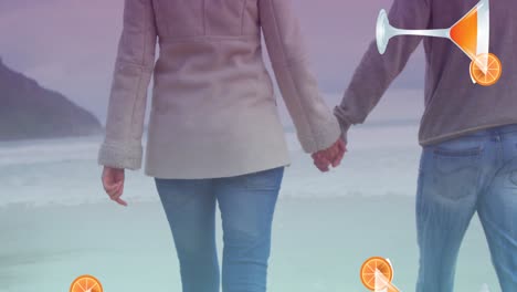 animation of cocktail glasses falling over caucasian couple in love holding hands by seaside