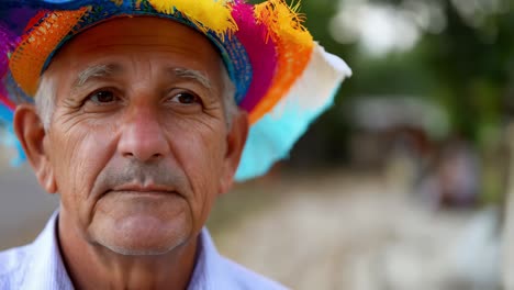 portrait of a senior man wearing a colorful hat