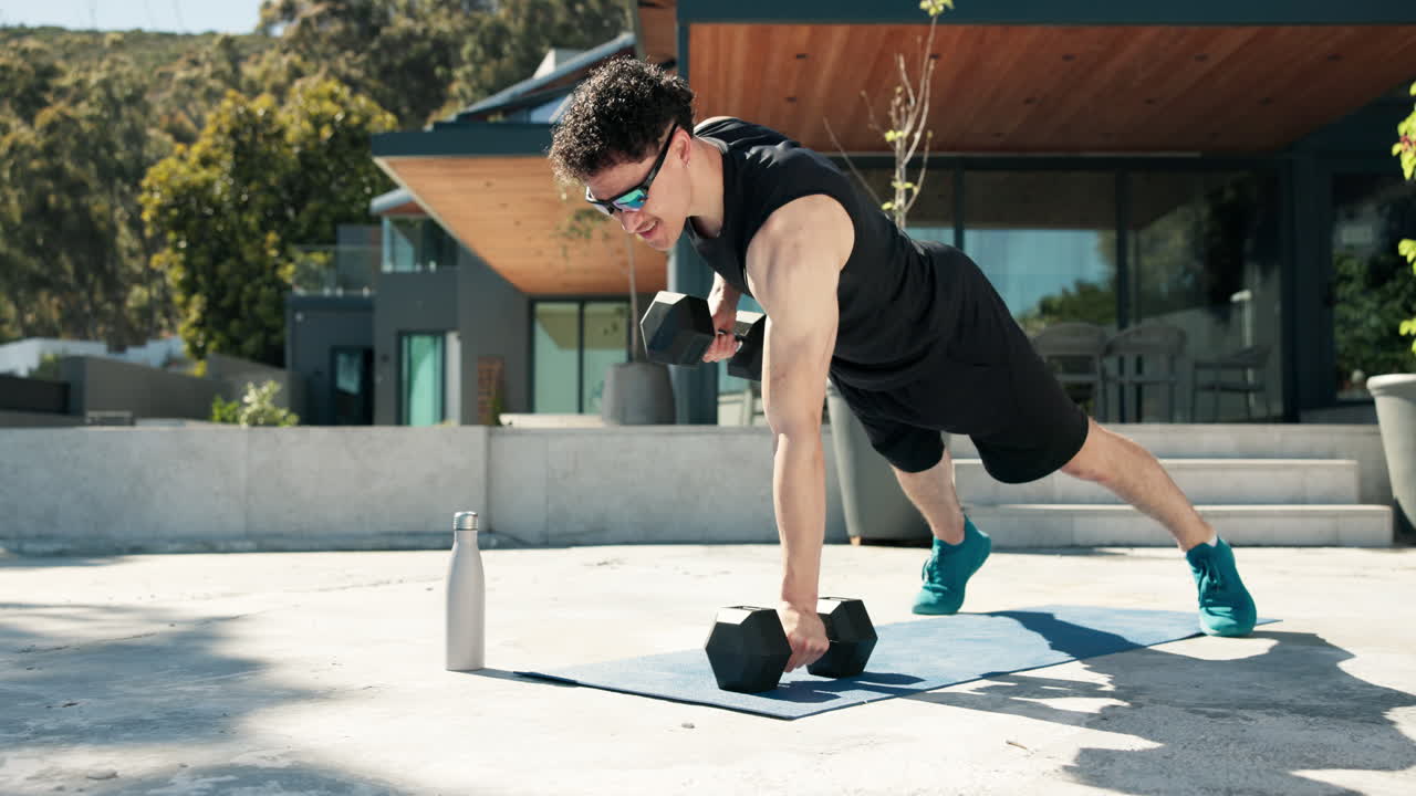 Athletic Man Performing Renegade Rows on Outdoor Patio