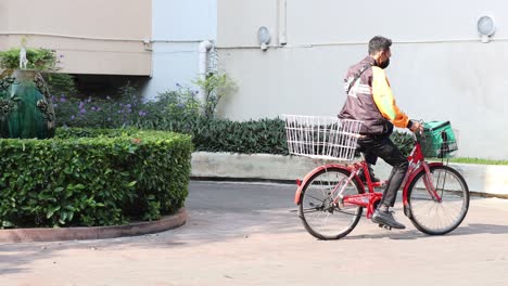 person delivering goods on a bicycle.