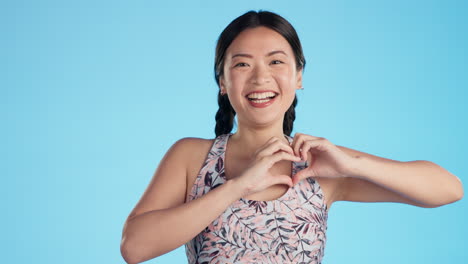 Asian-woman,-laughing-or-face-with-heart-hands