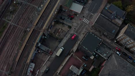 stationary-pan-up-reveal-drone-shot-of-downtown-London-city-skyline-hazy-day-from-empty-overground-railways