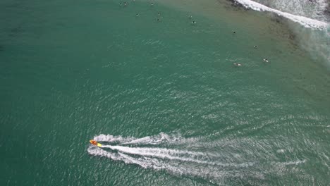 ocean scene with surfers and jet ski