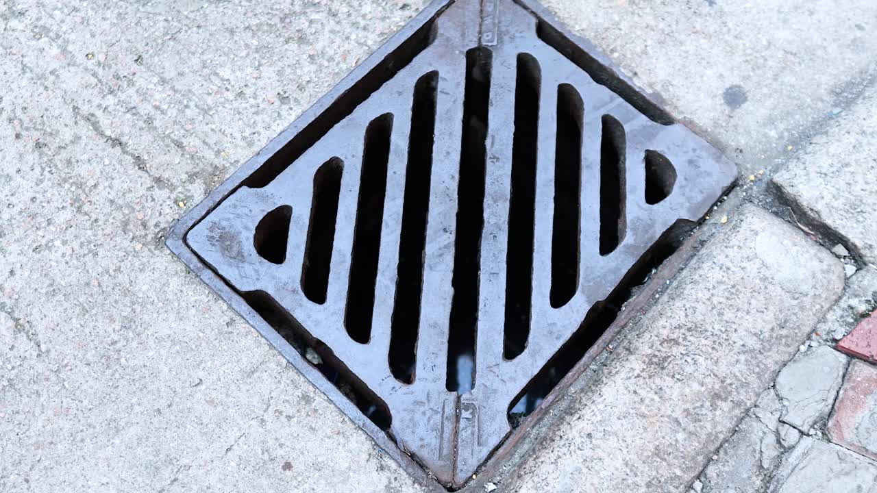 A person walks over a manhole cover
