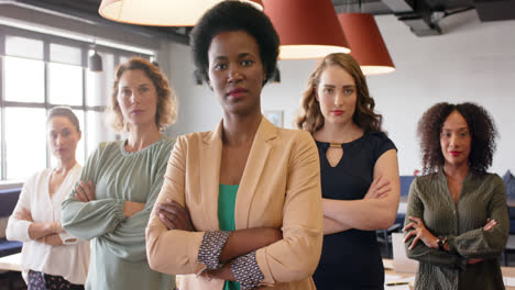 portrait of confident diverse businesswomen standing in office with arms crossed, in slow motion