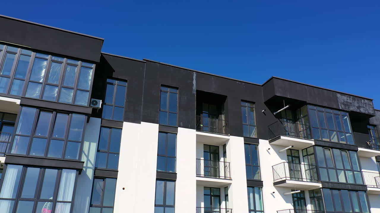 Contemporary residential building in the city. Exterior of a modern design of multistorey apartment building. Aerial view.