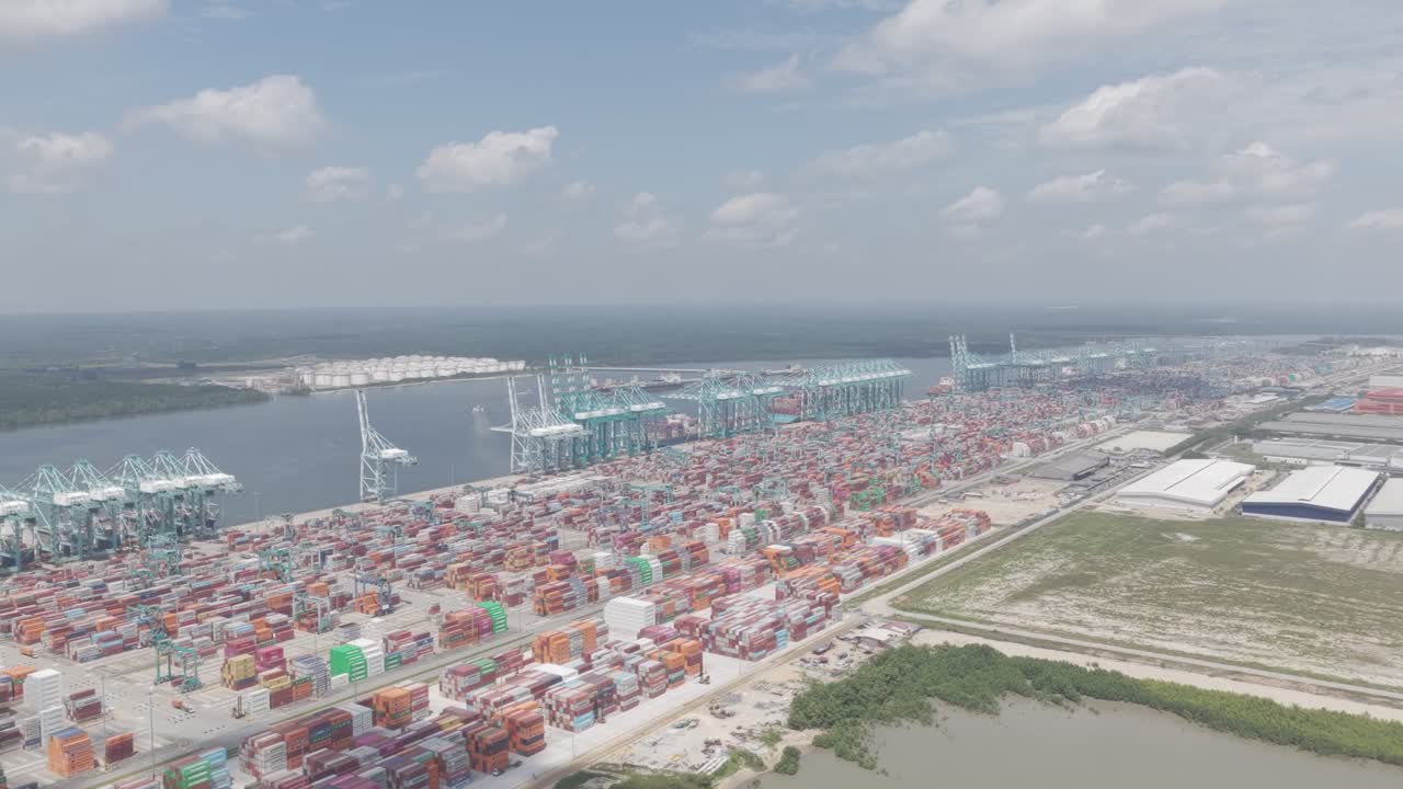 Aerial lateral shot of Tanjung Pelepas port showing container yards and cranes captured in dlog m color profile
