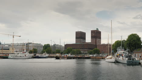 people stroll around the parliament building in oslo