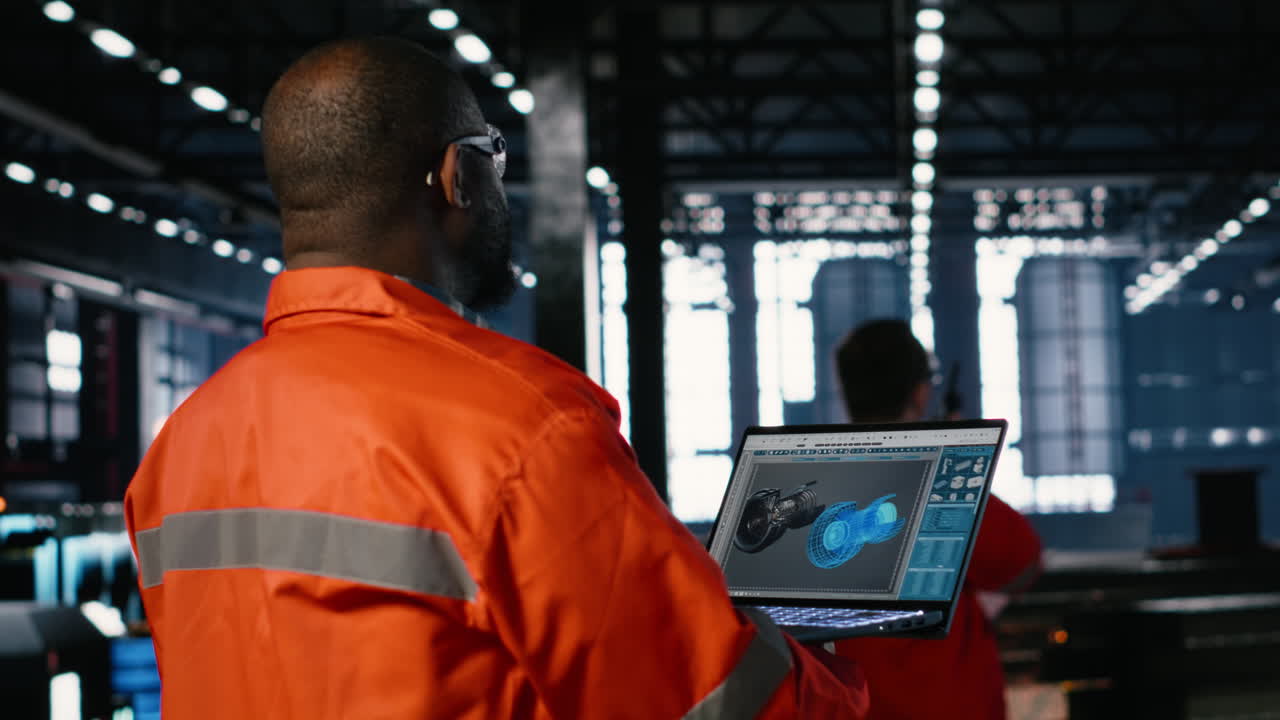 Engineer inspects turbine in industry plant and operating software on laptop