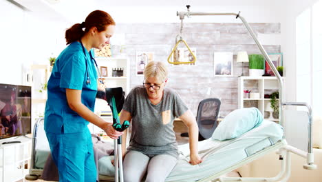 Social-worker-or-nurse-helping-an-elderly-woman-to-walk-with-crutches