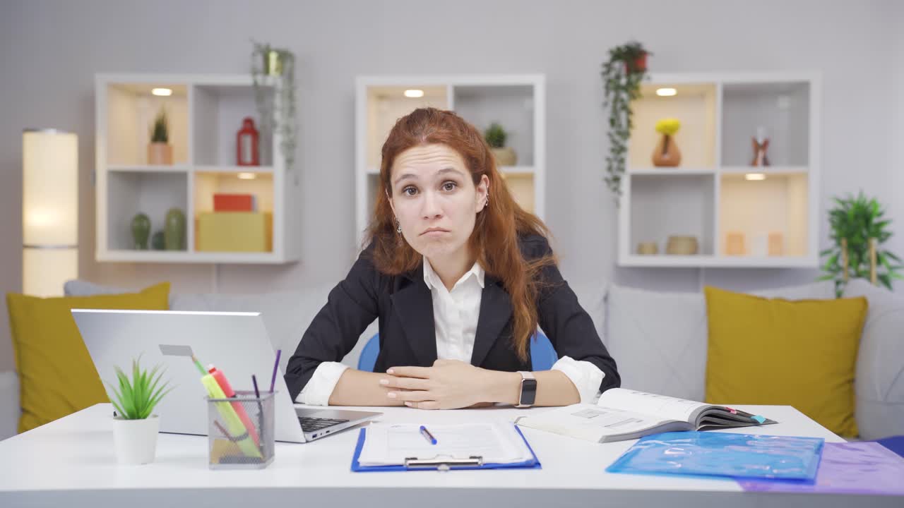 Home office worker woman looking at camera curious and confused.