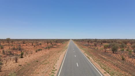 Drone-Vuela-Sobre-Mujer-Caucásica-Caminando-En-Uluru-Road