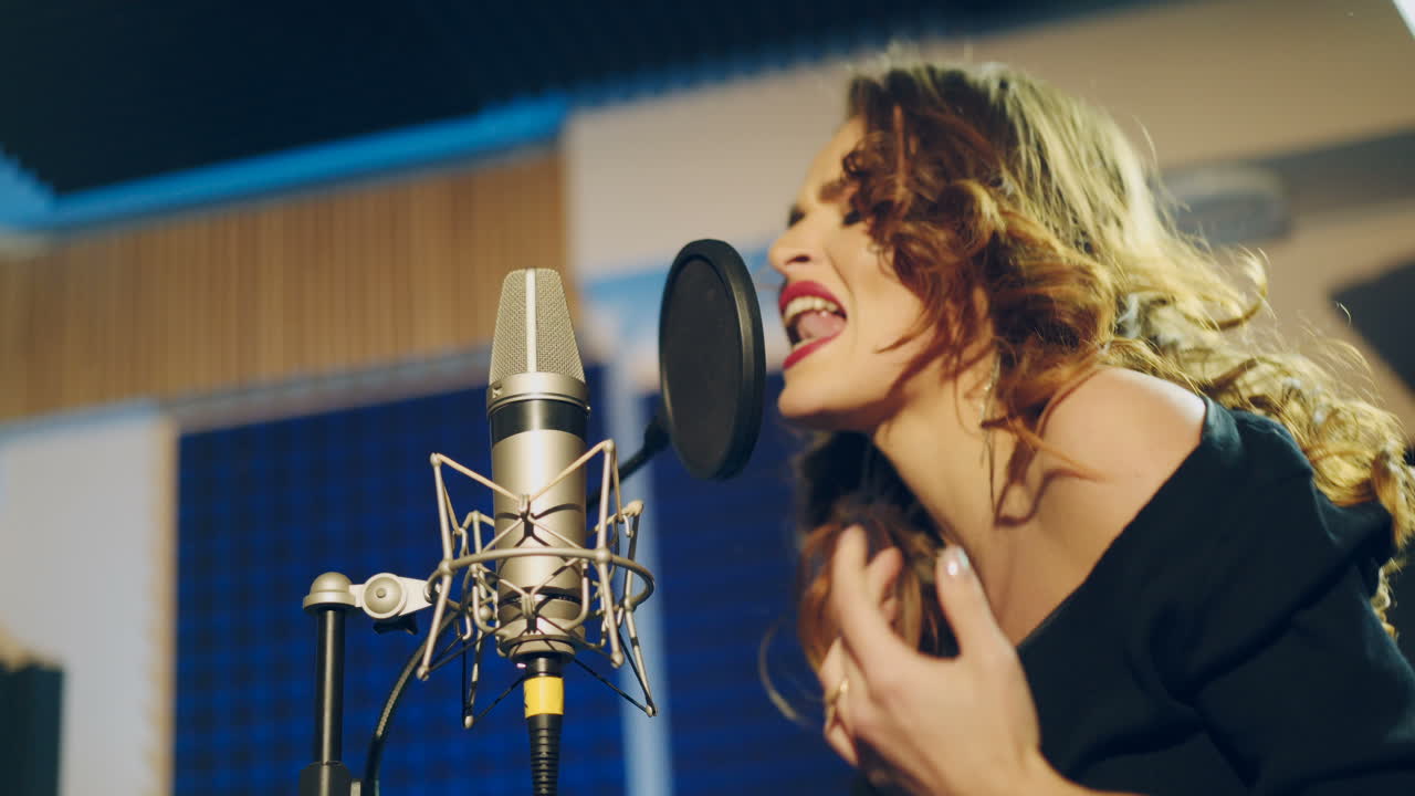 Woman singing in a recording studio. Female vocals. Professional recording studio.