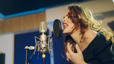 woman singing in a recording studio. female vocals. professional recording studio.