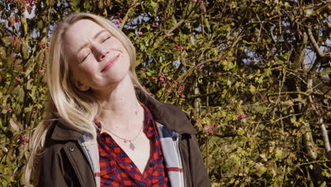 woman enjoying sunlight in nature
