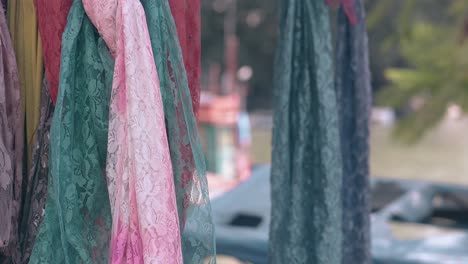 coloured lacy fabrics with images waved by light wind