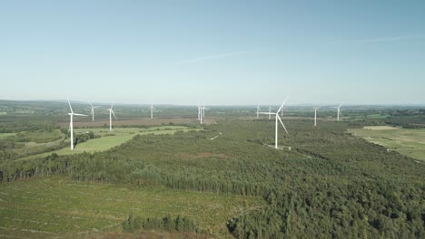 aerial view of wind turbines in a forest