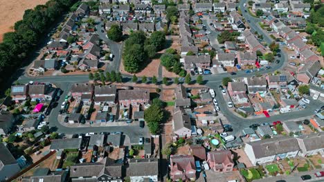 Aerial-drone-footage-of-the-small-Suffolk-village-of-Acton-surrounded-by-farmland-and-golden-fields