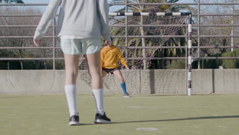 teenager girl doing penalty kick