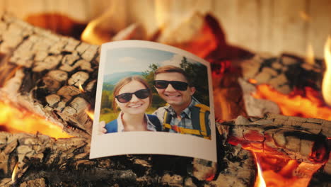 family vacation photos burning in a fireplace