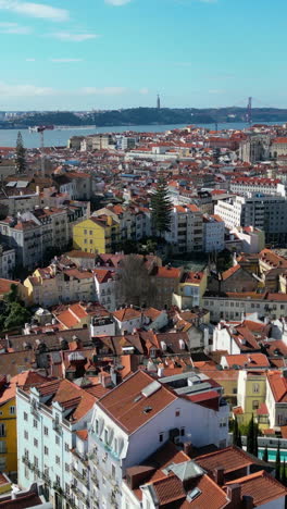 vertical drone shot over the moorish quarter and alfama area, in sunny lisbon