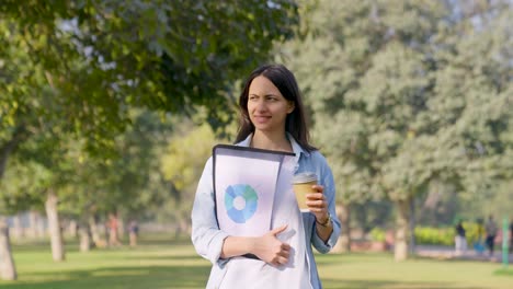 happy indian employee walking in a park