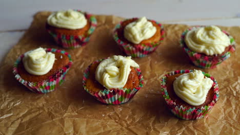 Chef-take-away-one-cupcake.-Six-cupcakes-on-cooking-paper