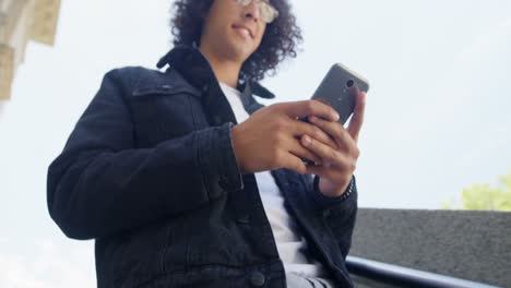 Man-using-mobile-while-moving-down-phone-4k