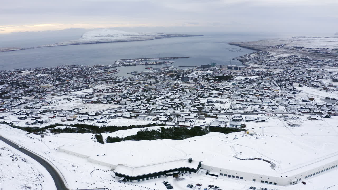 4K Slow Orbit of T&oacute;rshavn town covered in Snow, Faroe Islands