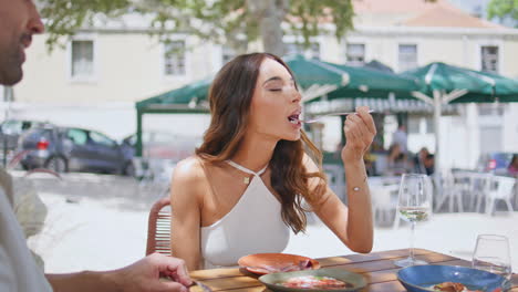 happy lady dinning street cafe with husband closeup. elegant pair eating lunch