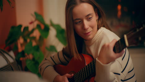 woman playing guitar writing song composing music