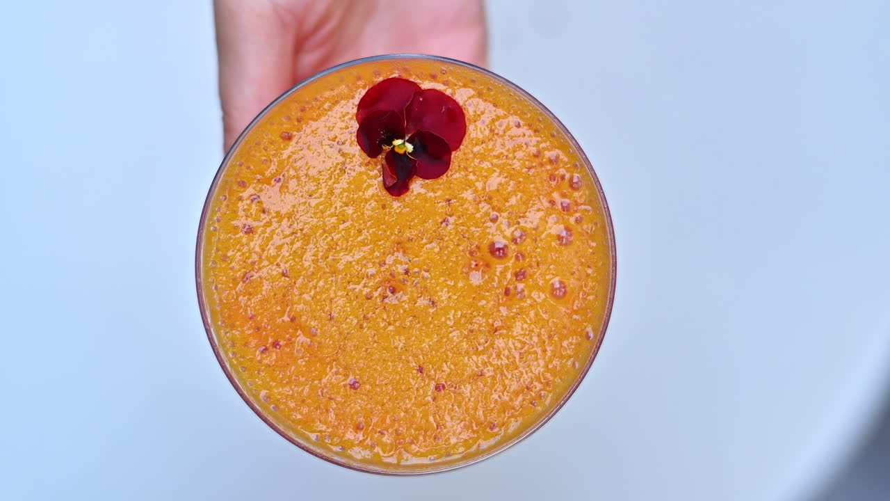 Woman hands on a red summer cocktail glass slow motion