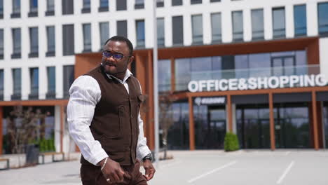 multiracial and satisfied young businessman turning his head and looking at something attentively. stylish man wearing white shirt walking to the workplace. success, people and business concept