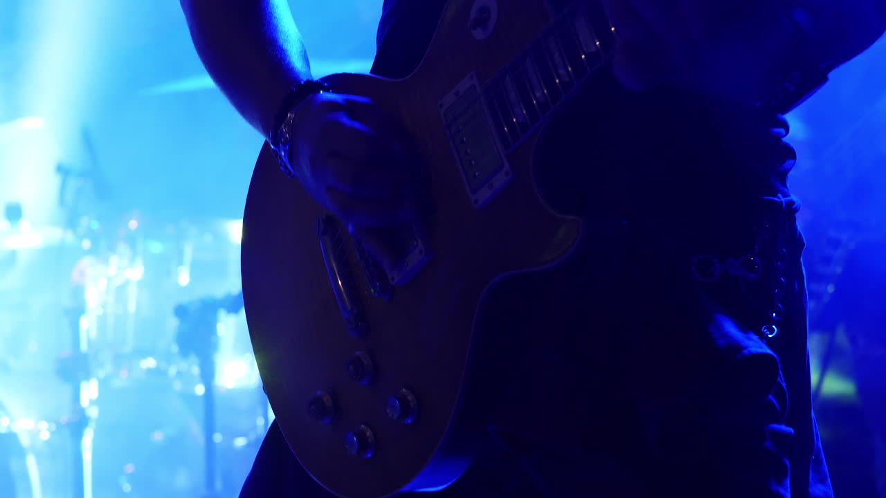 Having fun playing the lead guitar in a band on stage - close up