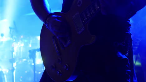 having fun playing the lead guitar in a band on stage - close up