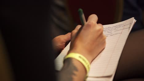 person taking notes at a conference