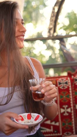 young woman enjoying turkish tea outdoors