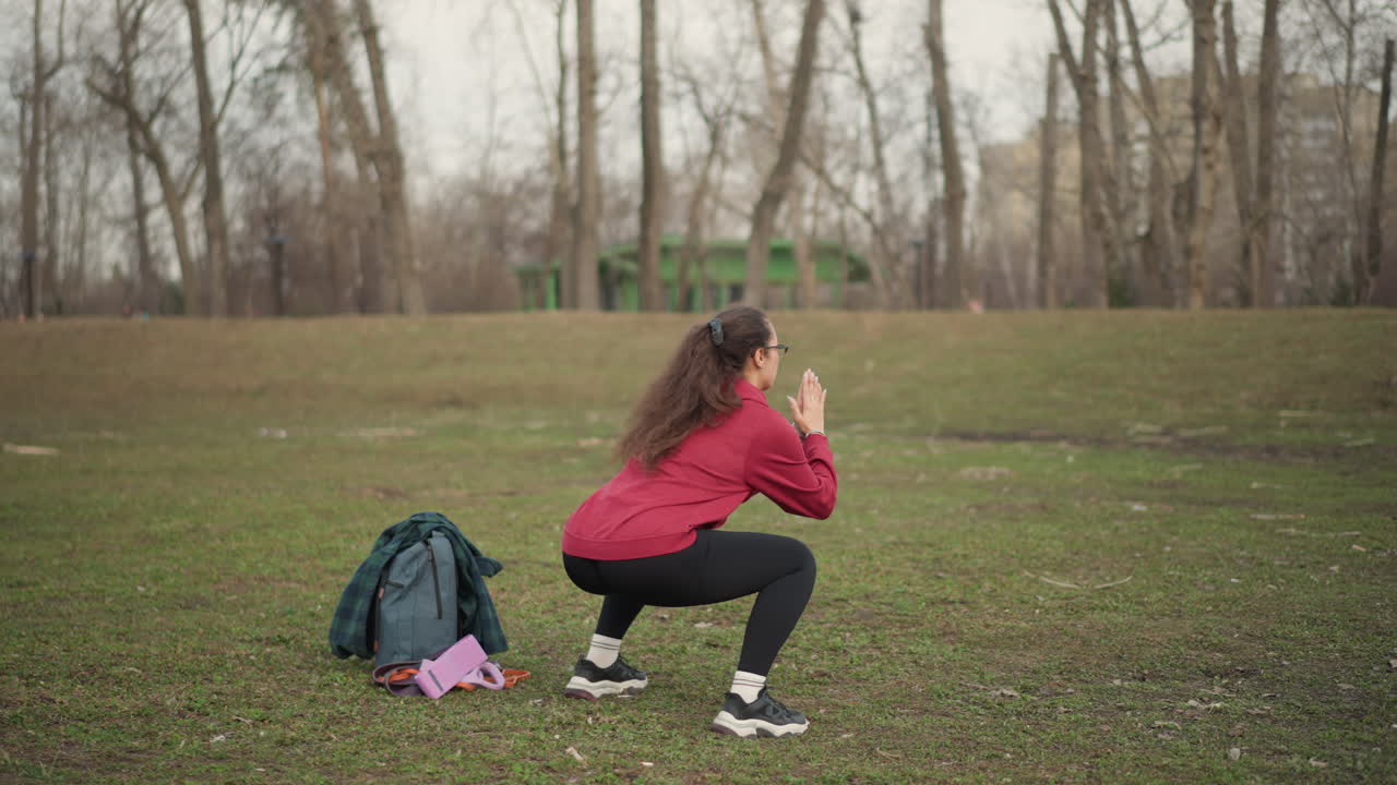 Vigorous Outdoor Lower Body Exercise, Dedicated Female Athlete Engages In Strenuous Outdoor Squat Training Session, Energetic Woman Executes Rigorous And Focused Outdoor Squat Workout Efficiently