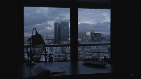 city view from a cozy home office at night