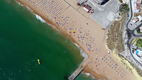 drone shot rising and twisting over the beach in albufeira